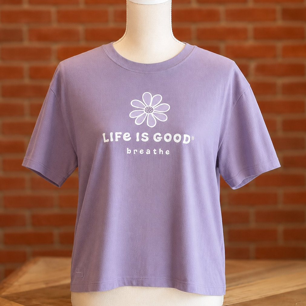 Dusk Purple Life is Good Fresh Daisy Breathe women’s tee featuring a white daisy graphic and “Life is Good Breathe” design.