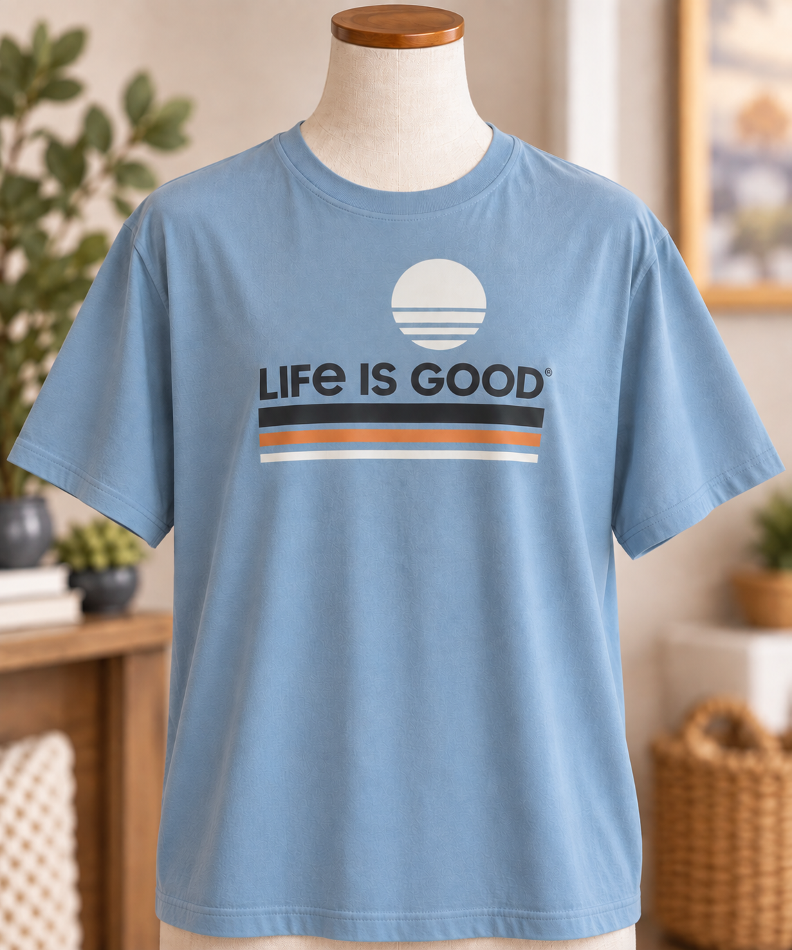 Life is Good men’s slate blue T-shirt featuring a retro sun and striped Life is Good graphic, displayed on a torso mannequin.
