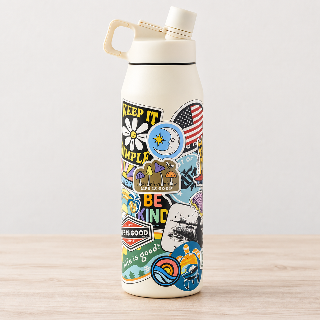 Life is Good ivory water bottle with colorful sticker collage on a neutral background.