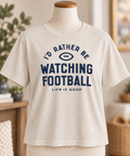Life is Good women’s I’d Rather Be Watching Football tee in Putty White displayed on a torso mannequin.