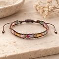Lotus and Luna Autumn Glow bracelet with multicolor stone beads and gold accents displayed on a neutral stone surface.