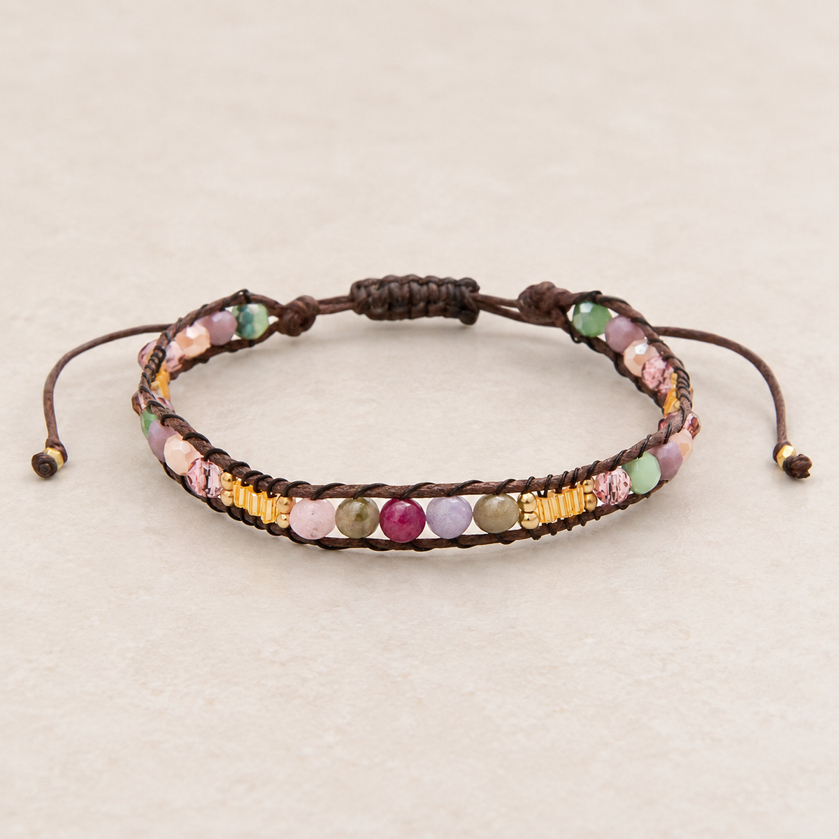 Lotus and Luna Autumn Glow bracelet with multicolor stone beads, gold accents, and brown adjustable cord.