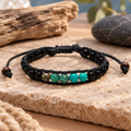 Lotus and Luna men’s Ocean Protector bracelet with black and turquoise beads on a neutral coastal-inspired background.